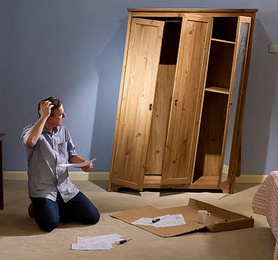 Frustrated woodworker struggling with an incomplete woodworking plan and wasted lumber